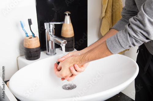 man washing his hands with plenty of foam due to the covid-19 pandemic