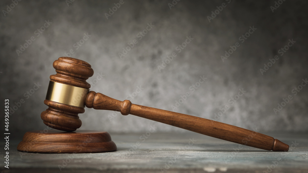 Wooden judge gavel on abstract background, close-up Wooden judge gavel on abstract background, close-up