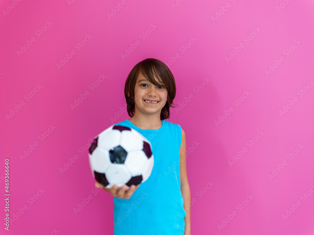 Portrait of young Arabic boy with soccer ball isolated against pink background and copy space Portrait of young Arabic boy with soccer ball isolated against pink background and copy space