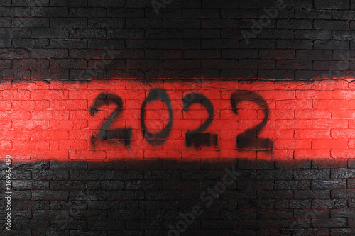 black numbers of new year 2022 on red brick wall