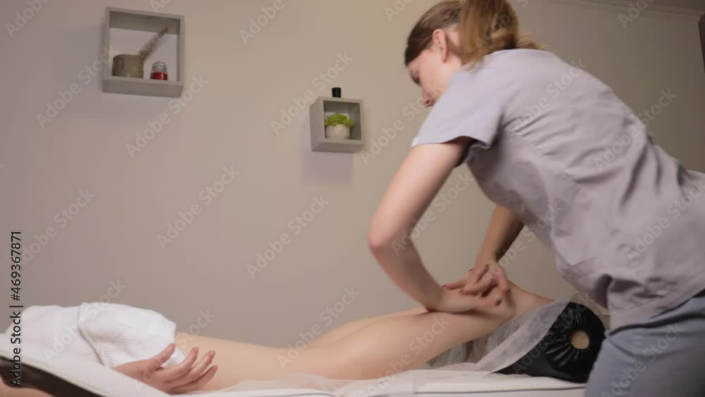 Woman masseur therapist kneading healthy legs feet massage relaxing professional therapy hands oil. Girl lying couch table resting gets rubdown spa salon body care concept slow motion treatment
Woman masseur therapist kneading healthy legs feet massage relaxing professional therapy hands oil. Girl lying couch table resting gets rubdown spa salon body care concept slow motion treatment