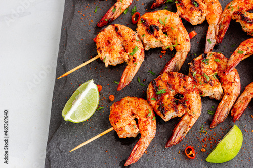 Barbecue Grilled Shrimp Skewers on a Platter Garnished with Lemon and Cilantro