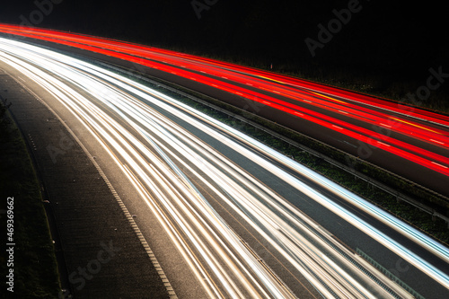 Light trails from a busy motorway or highway at night showing motion of traffic at rush hour. Traffic appears to drive on the right 