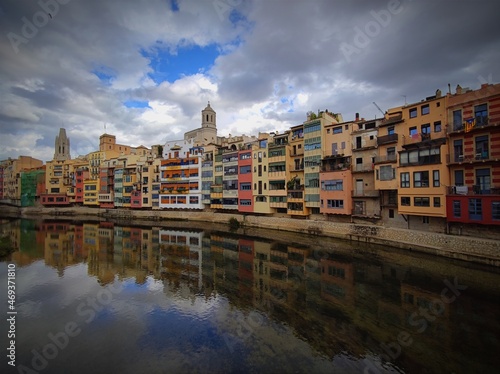 Colorful historical houses,facades, reflected in water of the river Onyar, in Girona, Catalonia, Spain.
