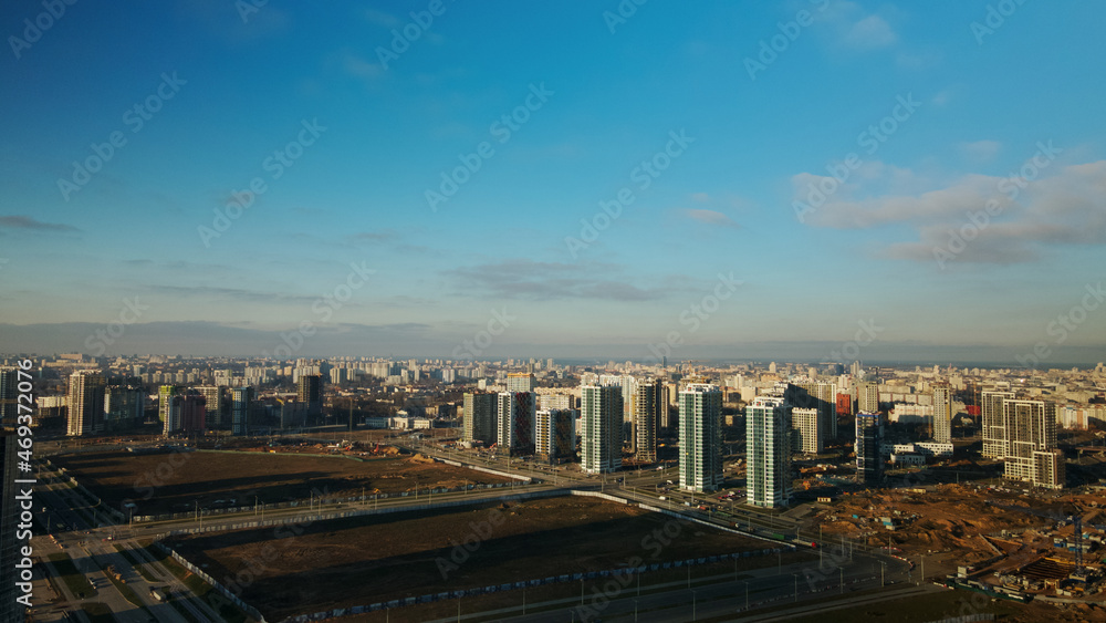 Construction site. Construction of modern multi-storey buildings. Against the background of the blue sky. Aerial photography.