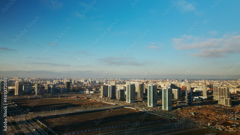 Fototapeta premium Construction site. Construction of modern multi-storey buildings. Against the background of the blue sky. Aerial photography.