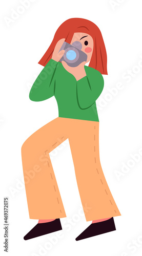 The girl is a photographer with a photo accessory . A girl with red hair and a green jacket takes pictures of the viewer. Simple style