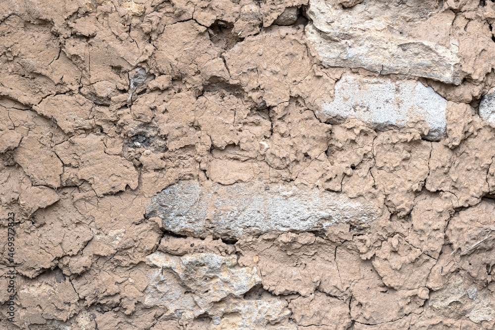 Clay wall. Clay background. Clay texture with stone Clay wall. Clay background. Clay texture with stone
