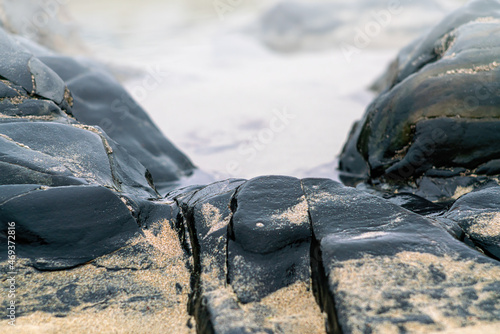 Wet rokcs and sand on low tide.