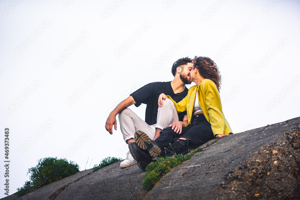 Young heterosexual couple kissing at the park