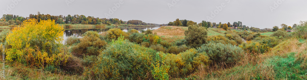 Autumn landscape panorama photography, the European part of the Earth. Druya, Belarus. Rural landscape with a rainy sky. Green field and village on the horizon Autumn landscape panorama photography, the European part of the Earth. Druya, Belarus. Rural landscape with a rainy sky. Green field and village on the horizon