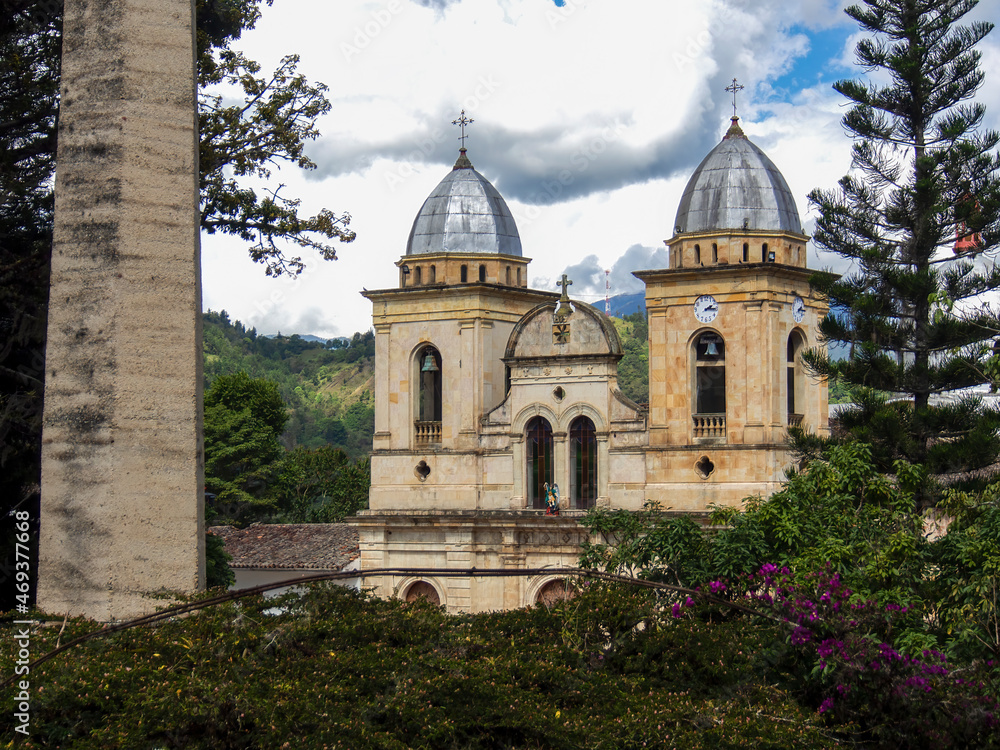 Facade of the church of san Miguel Arcangel in the town of Tenza, in central Colombia, viewed across the main park.
