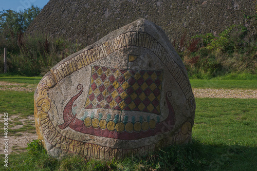 viking rune stone showing a colorful viking ship.
	 photo