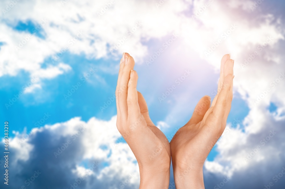 Hands of human praying on sky background with sunlight, Spirituality with believe and religion Hands of human praying on sky background with sunlight, Spirituality with believe and religion