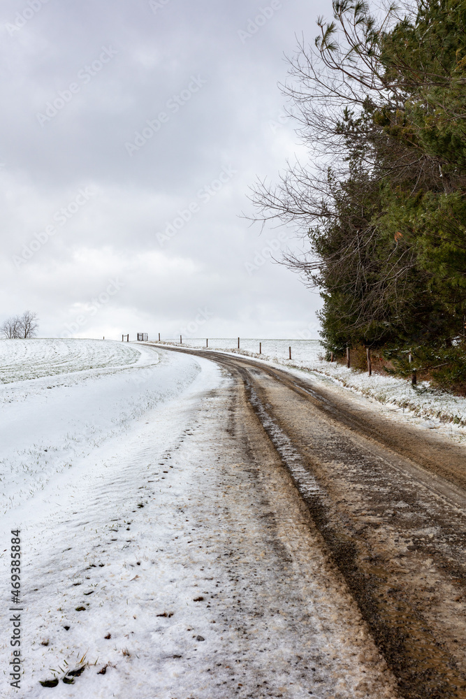 Snowy muddy winding country road Snowy muddy winding country road