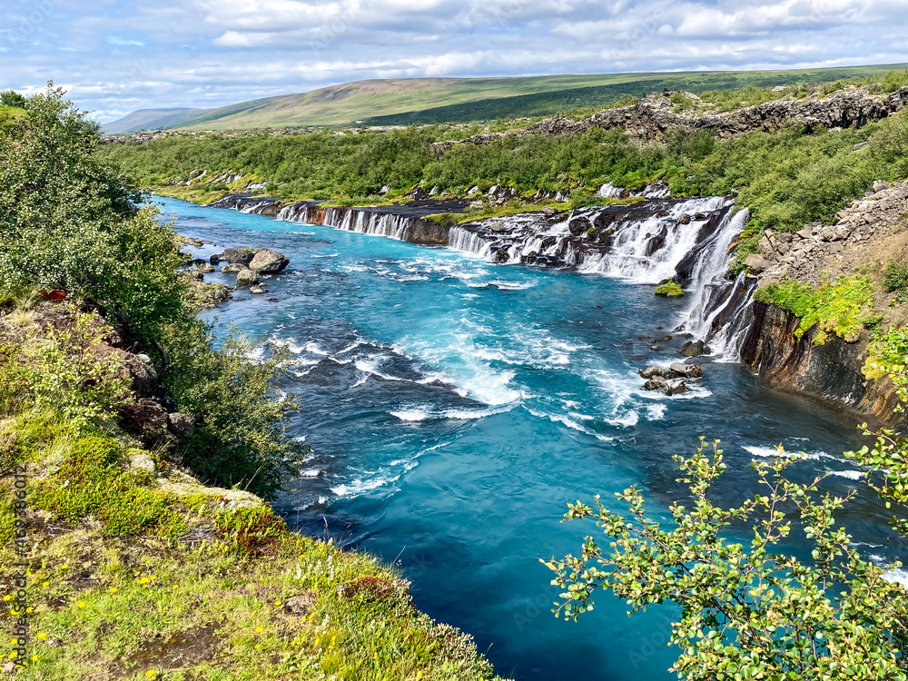 Beautiful landscape with waterfalls falling to a blue river in iceland
