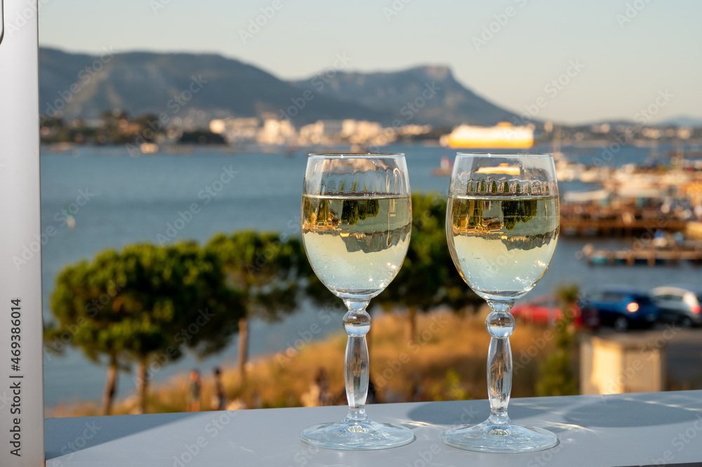 Summer on French Riviera, drinking cold white wine from Cotes de Provence on outdoor terrase with view on harbour of Toulon, Var, France Summer on French Riviera, drinking cold white wine from Cotes de Provence on outdoor terrase with view on harbour of Toulon, Var, France