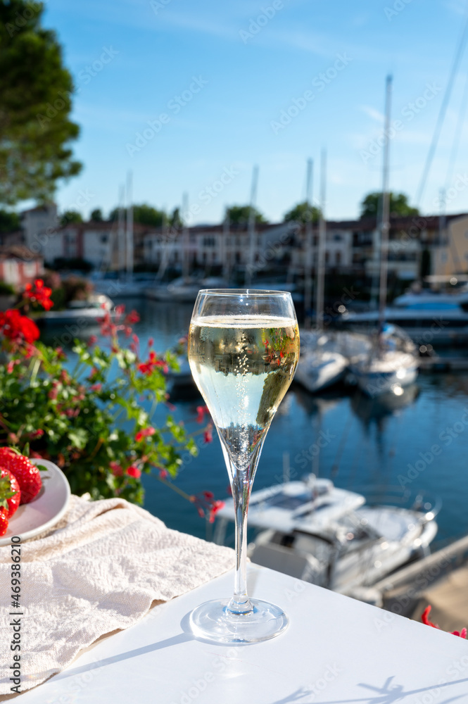 Summer party, pouring of French champagne sparkling wine in glasses in yacht harbour of Port Grimaud near Saint-Tropez, French Riviera vacation, France