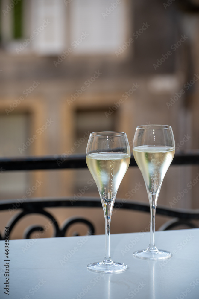 Romantic party with two glasses of white cold champagne and view on old street in French village Romantic party with two glasses of white cold champagne and view on old street in French village