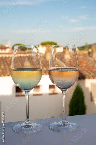 Summer on French Riviera Cote d'Azur, drinking cold rose and white wine from Cotes de Provence on outdoor terrase in Port Grimaud, Var, France