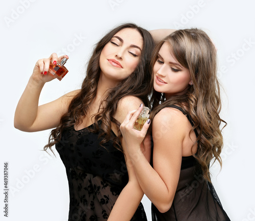 Perfume. Young girls smelling aroma with pleasure