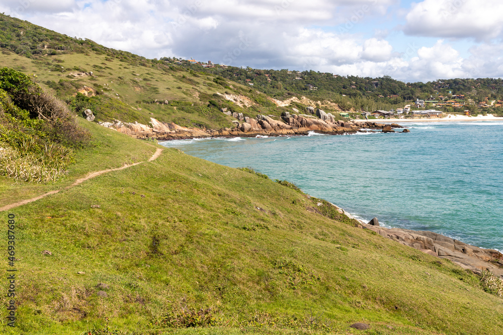 Trail to the beach with rocks and and vegetation