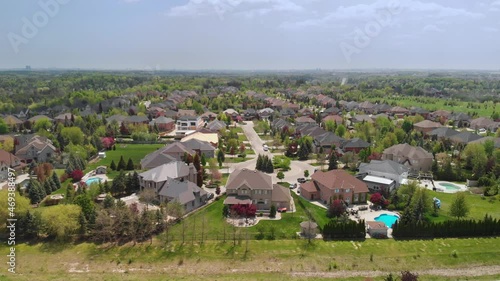 An aerial shot tracks right over a residential community in Kleinburg Ontario. photo