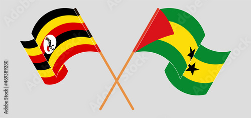 Crossed and waving flags of Uganda and Sao Tome and Principe