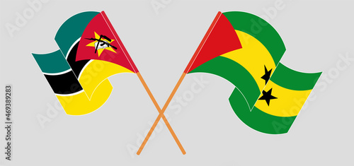 Crossed and waving flags of Mozambique and Sao Tome and Principe