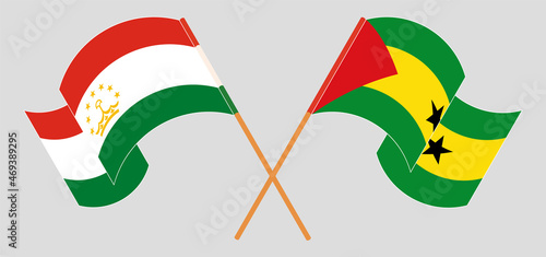 Crossed and waving flags of Tajikistan and Sao Tome and Principe