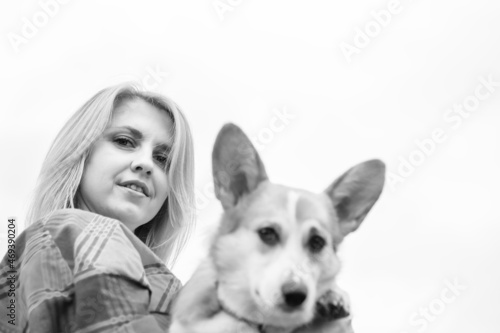 Portrait of a woman with a dog corgi breed.