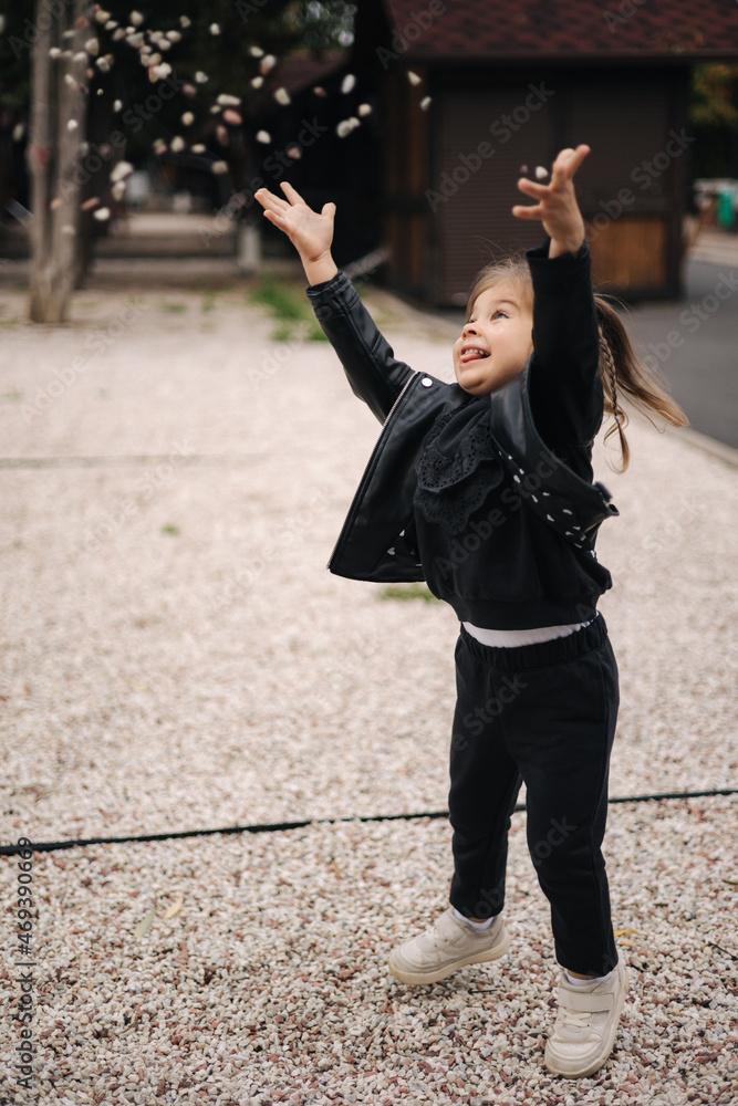 Little girl throw up little white pabbles Stock Photo Adobe Stock