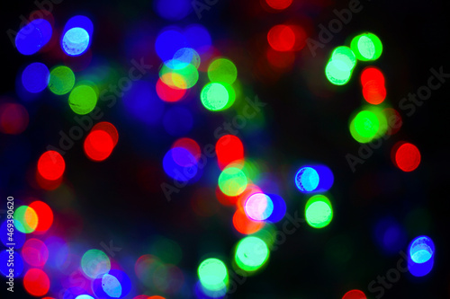 Defocus. Blurred background of festive lights. Red, green, blue