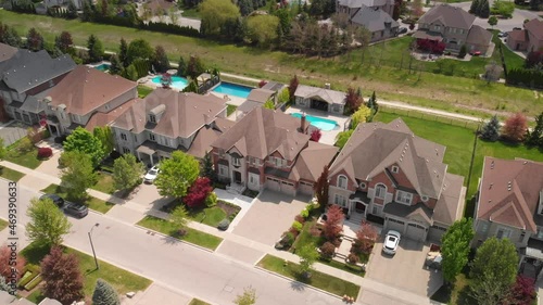 An aerial shot orbits over a residential community in Kleinburg Ontario. photo