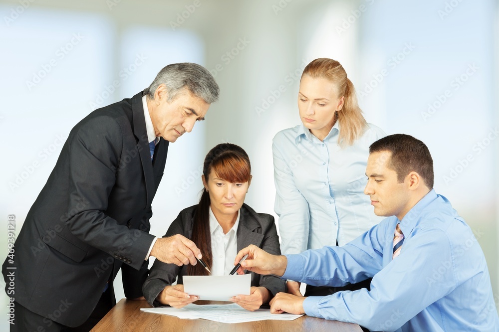 Diverse executive business people working on projects at boardroom meeting Diverse executive business people working on projects at boardroom meeting