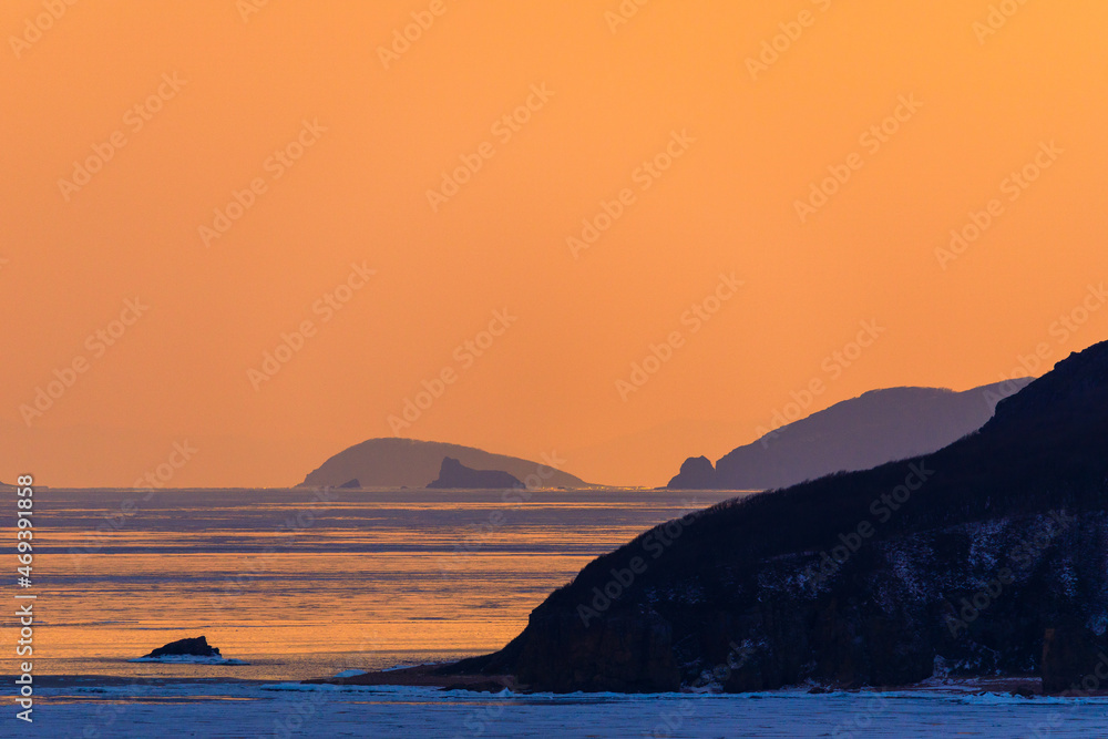 Picturesque islands in the Sea of Japan during a bright sunset. Beautiful seascape.