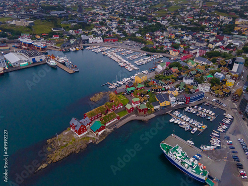 Beautiful aerial view of the City of Torshavn Capital of Faroe Islands- View of Cathedral, colorful buildings, marina, suburbs and Flag © Gian