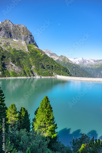Beautiful alpine walley with azure blue water dam