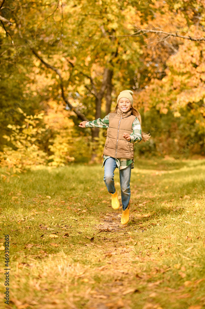 A girl in warm clothes playing in the park A girl in warm clothes playing in the park