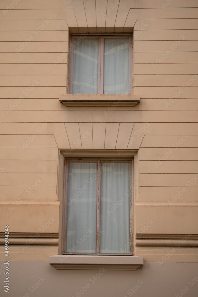 Windows of an old building with orange walls and lines Windows of an old building with orange walls and lines