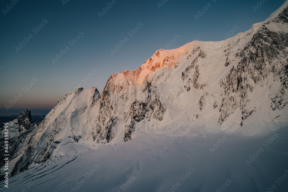 Famous Brenva face of Mont Blanc, the highest peak of Europe. Big alpine wall with snow, ice, seracs and creavasses. Peuterey ridge, sunrise over Brenva face of Mont Blanc, Chamonix, France. Famous Brenva face of Mont Blanc, the highest peak of Europe. Big alpine wall with snow, ice, seracs and creavasses. Peuterey ridge, sunrise over Brenva face of Mont Blanc, Chamonix, France.