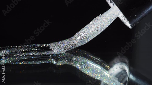 Brush manicure and pedicure draws a silver line of gel nail polish