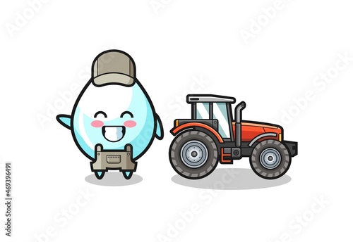 the milk drop farmer mascot standing beside a tractor