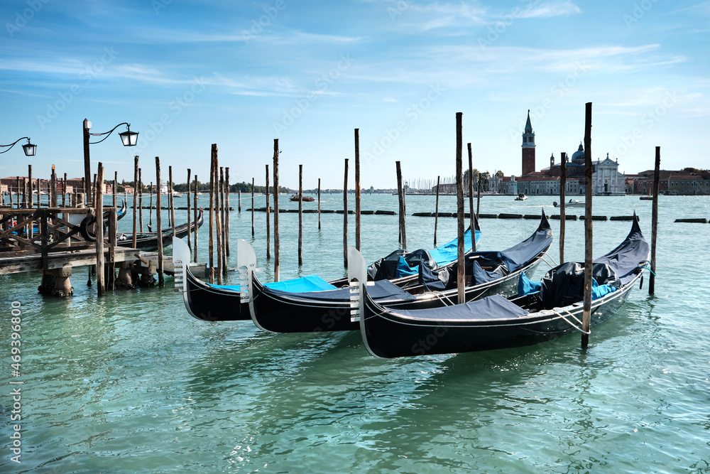 Venice gondolas. Gondolas moored by Saint Mark square with San Giorgio di Maggiore church in the background. Venice, Venezia, Italy, Europe.