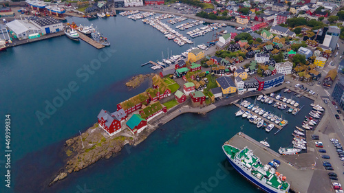 Beautiful aerial view of the City of Torshavn Capital of Faroe Islands- View of Cathedral, colorful buildings, marina, suburbs and Flag photo