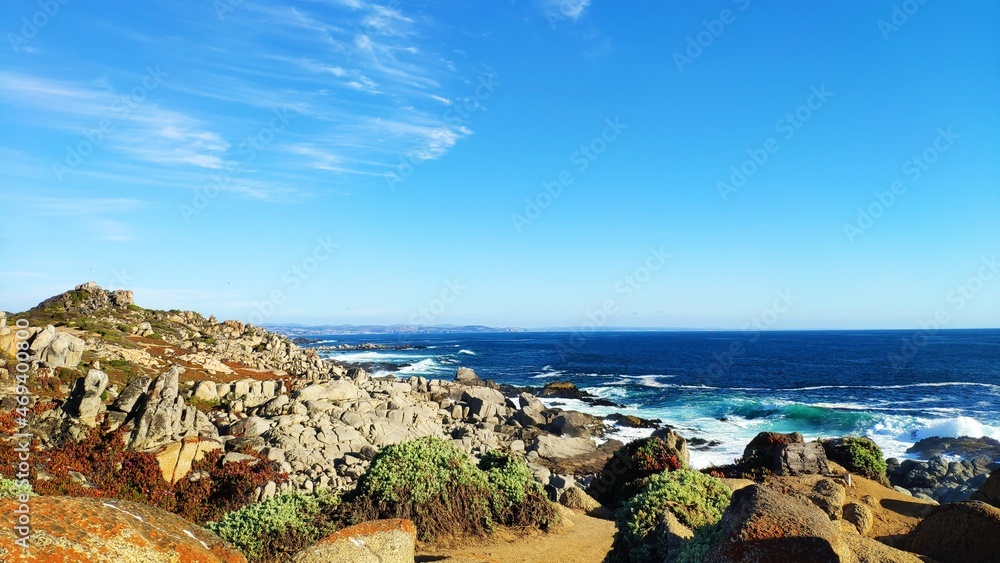  Rocky beach and blue ocean on a sunny day at Punta de Tralca, Chile.