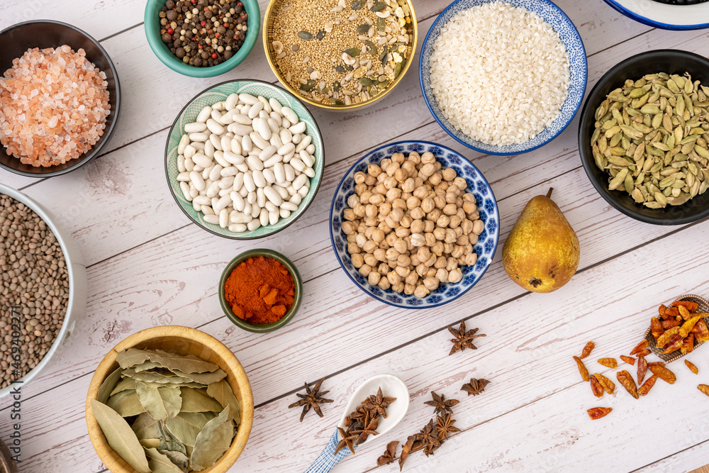 Image of ingredients inside pretty bowls viewed from the top on a white wood plank table with worn paint Image of ingredients inside pretty bowls viewed from the top on a white wood plank table with worn paint