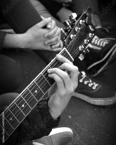 person playing guitar, hand with guitar