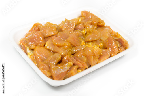 Tray of chicken pieces on a white background