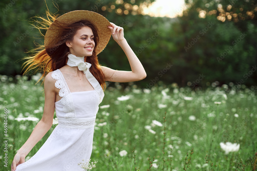 beautiful woman in a hat in a field with flowers walk beautiful woman in a hat in a field with flowers walk